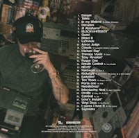 a man is sitting in front of a computer with headphones on